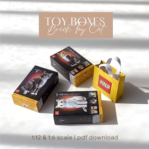 May include: Four toy boxes and a yellow paper bag with the word "YOLO" printed on it. The boxes feature images of cats and the text "TOY BOXES Brick Toy Cat". The scale is 1:12 & 1:6.