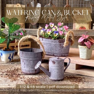May include: Miniature watering can and bucket set in a rustic metal style. The set includes a small watering can, a bucket with a rope handle, and a larger planter filled with colorful flowers. The image also includes small potted plants.