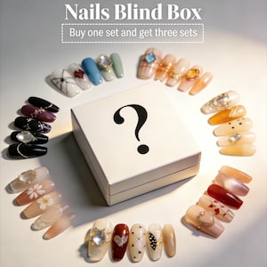May include: A collection of handmade press-on nails in various colors and designs, including white, black, blue, and nude tones, with decorative elements. The image includes a blind box with a question mark and the text "Buy one set and get three sets."