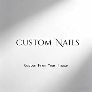May include: A white graphic design featuring the black text CUSTOM NAILS in a serif font, positioned above the smaller black text Custom From Your Image. The background is a plain, solid white surface with a subtle light grey gradient shadow.