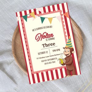 May include: A birthday invitation with a circus theme. The invitation features red and white stripes, a banner, and a cartoon monkey holding a banana. Text includes the name "Nolan", the age "Three", and event details.