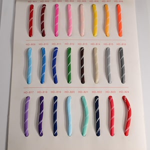 May include: A color swatch card featuring twenty-four braided cords in various colors, each with a white diagonal stripe pattern. The cords are arranged in three rows of eight, labeled with codes from HD-801 to HD-824 printed in red above each cord.