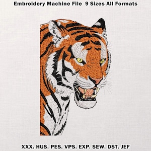 May include: An embroidered tiger head with orange and black stripes, white accents, and yellow eyes. The tiger is roaring, showing its teeth. Text at the top reads "Embroidery Machine File 9 Sizes All Formats".