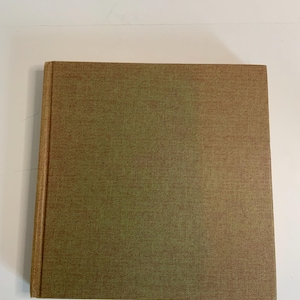 May include: A brown and green hardcover book with a textured cover.