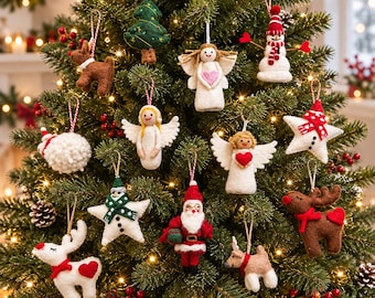 May include: A collection of felt Christmas tree ornaments including angels, a snowman, a Santa Claus, reindeer, a star, and a tree. Each ornament features a hanging string and is displayed on a green pine tree with warm white lights.