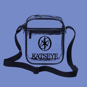 May include: A white ceramic mug with a black handle and the text "But First, Coffee" in a handwritten style. The mug is on a white surface. The mug is approximately 4 inches tall.
