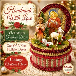 May include: A round decorative box featuring a red and green striped pattern with gold trim. On top, a figurine of a praying child stands beside a white lamb, while a circular backdrop displays an angel holding a dove. Green holly leaves accent the base.