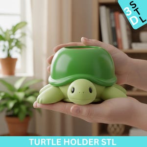 May include: A green turtle-shaped holder with a round opening, held in hands. The turtle has a light green body and a darker green shell. The text "TURTLE HOLDER STL" is at the bottom.