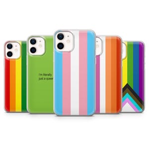 May include: A collection of phone cases with various pride flag designs. The cases feature the rainbow pride flag, transgender flag, and other LGBTQ+ symbols. One case has the text "I'm literally just a queer".