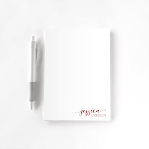 May include: A set of three ceramic mugs with a speckled, matte finish. The mugs are in shades of cream, light gray, and dark gray. Each mug has a simple, minimalist design and a rounded handle.