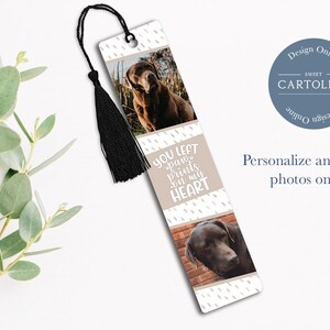 May include: A white bookmark with a black tassel. The bookmark features two photos of a brown dog and the text "YOU LEFT paw prints on my HEART".