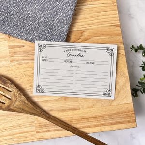 May include: A white recipe card with a black border and a handwritten title that reads "Made with love by Grandma". The card has sections for recipe serves, prep time, cook time, and ingredients.