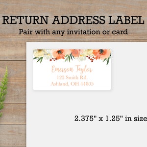 May include: A return address label with a floral design featuring peach and white flowers, green leaves, and red berries. The label includes the text "Emerson Taylor", "123 Smith Rd.", "Ashland, OH 44805", and measures 2.375 inches by 1.25 inches.