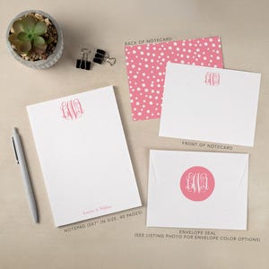 May include: A stationery set with a white notepad, notecards, and an envelope, each with a pink monogram. The notepad is 12.7 x 17.8 cm and has 40 pages. The back of the notecard has a pink polka dot pattern.