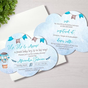 May include: Cloud-shaped baby shower invitations with watercolor hot air balloon and banner illustrations. The text reads "Up, Up & Away!" and includes event details. The invitations are on a white background.