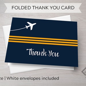May include: A folded thank you card with a navy blue background and white airplane graphic. The card has three yellow stripes and the text "Thank You" in white cursive font. The card is A2 size and includes white envelopes.