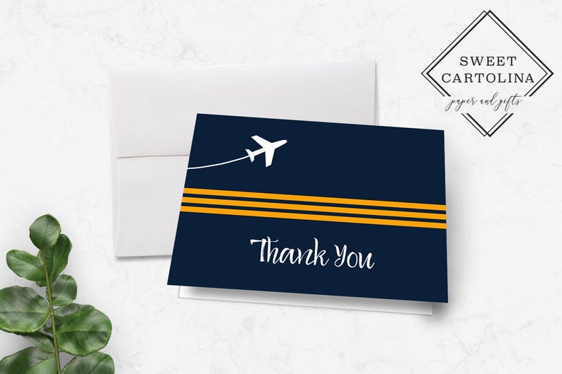 May include: A navy blue thank you card with a white airplane and three yellow stripes. The text "Thank You" is written in white cursive.