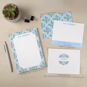 May include: A stationery set featuring a notepad, notecards, and an envelope. The notepad measures 5x7 inches and has 40 pages. The set has a blue and white floral design. The notecards and envelope seal are also decorated with the same pattern. The name "JANE ANDERSON" is printed on the notepad and notecards.