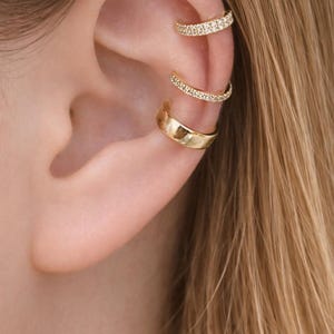 May include: A handmade, wooden cutting board with a natural finish. The board features a live edge on one side and a smooth, rectangular shape. It is approximately 18 inches long and 12 inches wide.