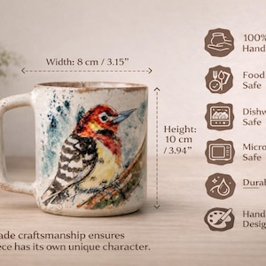 May include: A ceramic mug featuring a hand-painted woodpecker illustration, measuring 3.15 inches in width and 3.94 inches in height. The mug is labeled as 100% handmade, food safe, dishwasher safe, microwave safe, with a durable glaze finish.
