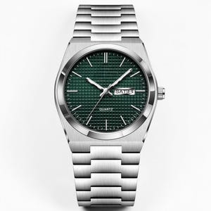 May include: A silver-toned quartz watch with a green dial and a matching silver band. The watch face displays the day and the word "QUARTZ". The watch has a rectangular case and a link-style bracelet.