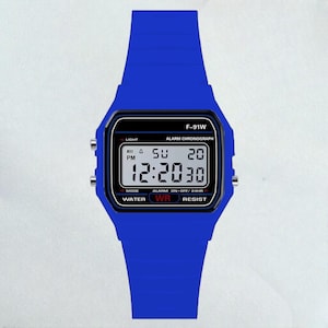 May include: A blue digital watch with a matching blue band. The watch face displays the time, day, and date. The watch has the text "F-91W" and other function labels. The watch is water resistant.