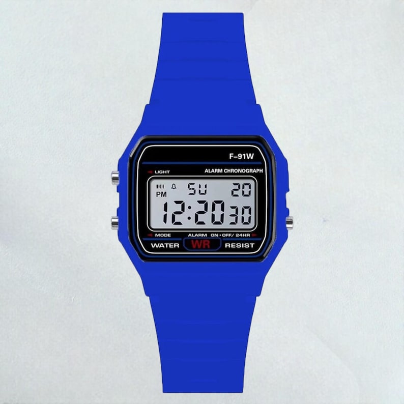 May include: A blue digital watch with a matching blue band. The watch face displays the time, day, and date. The watch has the text "F-91W" and other function labels. The watch is water resistant.