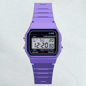 May include: A digital watch with a purple band and case. The watch face displays the time, day, and date. The watch has the text "F-91W" and other text including "ALARM CHRONOGRAPH", "WATER WR RESIST".