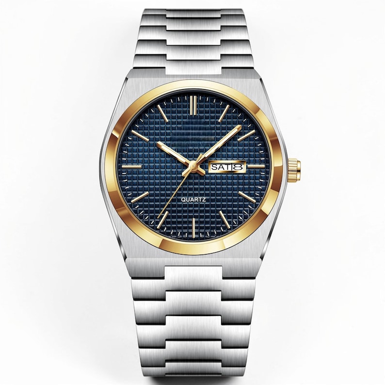 May include: A silver-toned wristwatch with a gold-colored bezel and a blue dial. The watch features gold-colored hands and hour markers, with the day of the week displayed. The watch band is made of silver-toned metal.