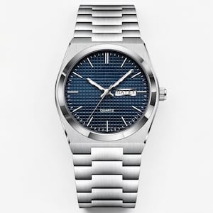May include: A silver-toned quartz watch with a blue textured dial and a date display. The watch has silver hands and markers, and a matching silver link bracelet. The watch face reads "QUARTZ" at the bottom.