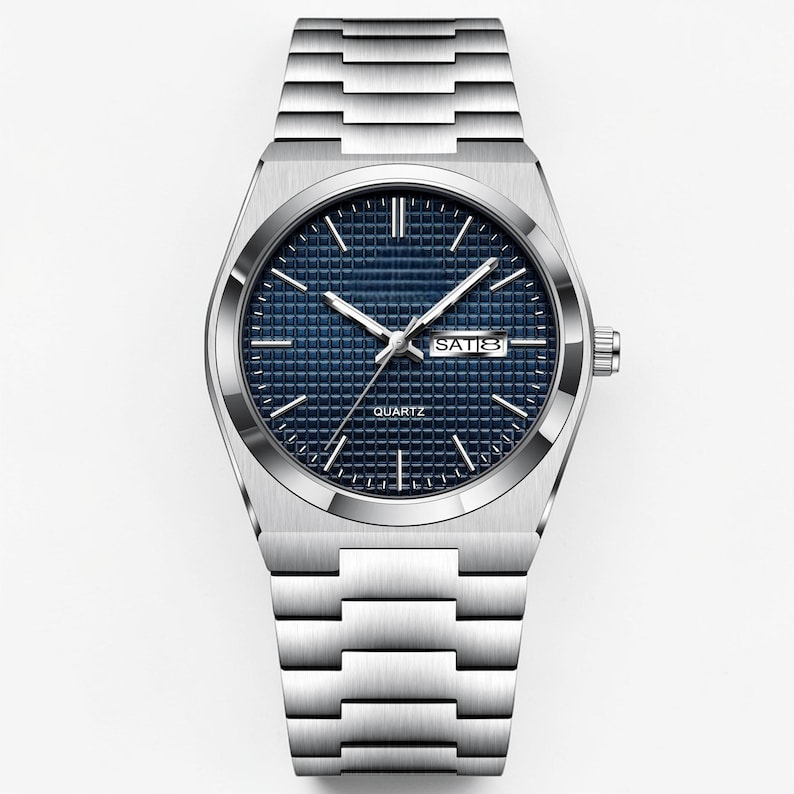 May include: A silver-toned quartz watch with a blue textured dial and a date display. The watch has silver hands and markers, and a matching silver link bracelet. The watch face reads "QUARTZ" at the bottom.