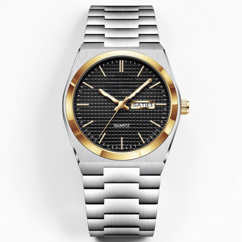 May include: A silver-toned quartz watch with a black face and gold-colored bezel. The watch features gold hands and hour markers, with a date display at the 3 o'clock position. The watchband is made of silver-toned metal.