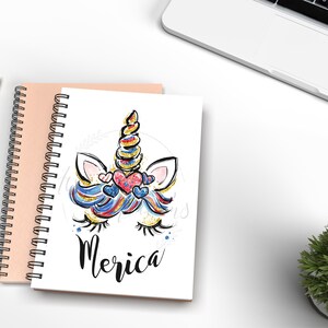 May include: A white spiral notebook with a colourful unicorn illustration and the word "Merica" on the cover. The unicorn has a blue, red and white mane and tail with glitter accents. The unicorn has pink ears and a gold horn.