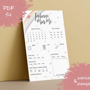 May include: A white printable PDF file with the text "Indovina Mini Me" and a rainbow illustration. The design includes spaces for baby details like birth date, time, weight, and eye color. The words "PDF file" are in the upper left corner.