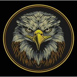 May include: Embroidered patch featuring a detailed eagle head. The eagle has gray and brown feathers, a yellow beak, and intense eyes. The design is set within a black circle with a gold border, creating a striking emblem.