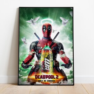 May include: A framed poster featuring Deadpool from Deadpool 2, holding a bottle of a beverage. The poster has a green and orange background with white doves and a halo above Deadpool's head. The text "DEADPOOL 2" and "ONLY IN CINEMAS" are at the bottom.