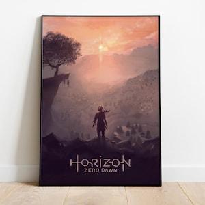Op de afbeelding: Een ingelijste kunstprint met een landschap uit de game "Horizon Zero Dawn". De afbeelding toont een figuur op een berg, uitkijkend over een vallei met een zonsondergang. De titel "Horizon Zero Dawn" staat onderaan.