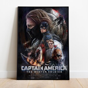 May include: A framed Captain America: The Winter Soldier movie poster. The artwork features Captain America, Bucky Barnes, Nick Fury, and other characters. The poster has a dark color scheme with a focus on the characters' faces and action scenes.