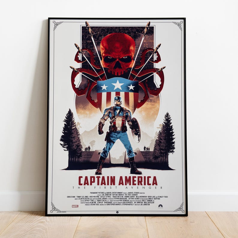May include: A framed Captain America movie poster. The poster features Captain America in a heroic pose, with a red skull and tentacles above him. The title "Captain America: The First Avenger" is displayed at the bottom.