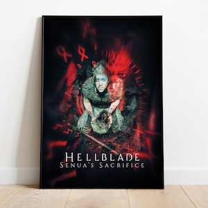 May include: A framed poster featuring the game "Hellblade: Senua's Sacrifice." The artwork depicts a woman with a distressed expression, surrounded by red, abstract shapes and runes. The title and subtitle are displayed in white text at the bottom.