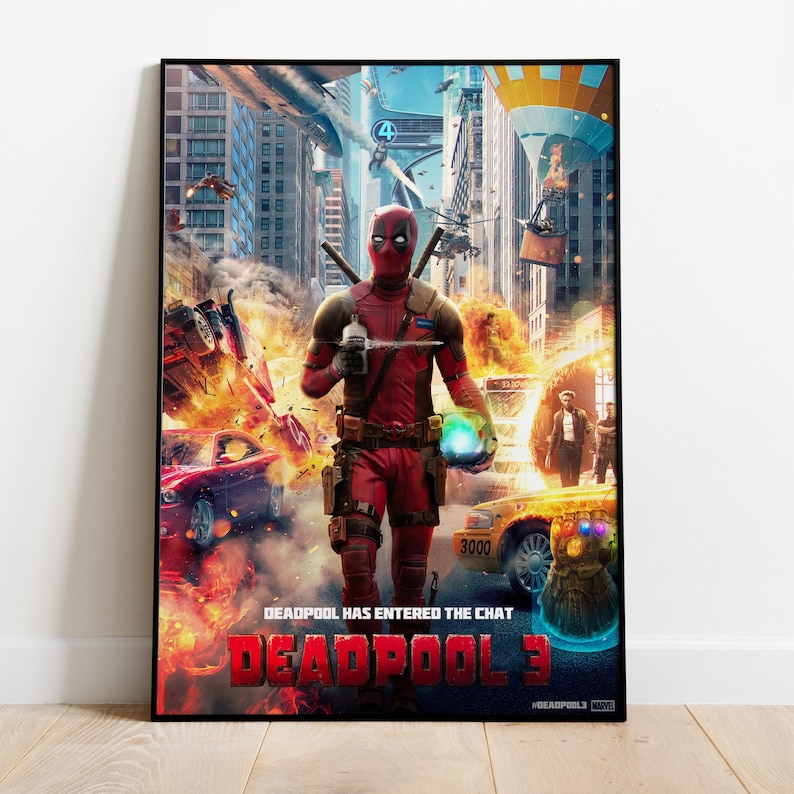May include: A framed poster featuring Deadpool from Deadpool 3. The image shows Deadpool in his red and black suit, holding a weapon, with a city scene in the background. The poster has the text "DEADPOOL HAS ENTERED THE CHAT" and "DEADPOOL 3".