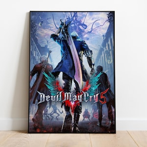 May include: A framed poster featuring the "Devil May Cry 5" video game. The artwork depicts three characters in a city setting, with the central figure holding a large sword. The game's logo is prominently displayed with a red and teal design.