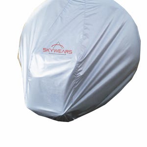 May include: A silver-coloured cover with the text "SKYWEARS" in red. The cover appears to be made of a lightweight, possibly waterproof material. The cover is designed to fit over an object, likely for protection from the elements.