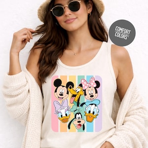 A woman wearing a white tank top with a colorful graphic of Disney characters, including Mickey Mouse, Minnie Mouse, Donald Duck, Goofy, and Pluto, posing against a white background.