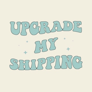 May include: A retro-style graphic with the words "UPGRADE MY SHIPPING" in light blue bubble letters. The text is centered on a cream-colored background, with small blue star shapes scattered around the text.