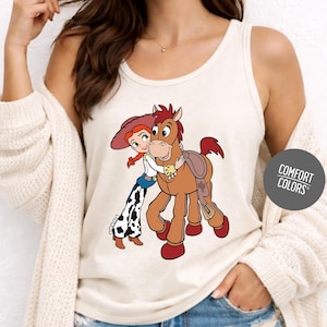 A woman wearing a white tank top with a cartoon image of a girl and a horse printed on it.
