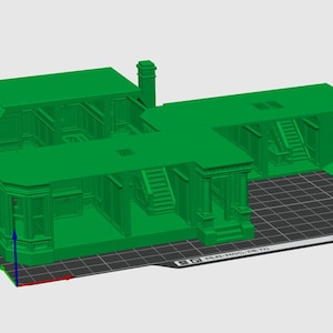 May include: A bright green 3D printed model of a multi-room building structure featuring architectural details such as bay windows, interior staircases, and doorways. The model is displayed on a digital grid platform with a coordinate axis indicator.