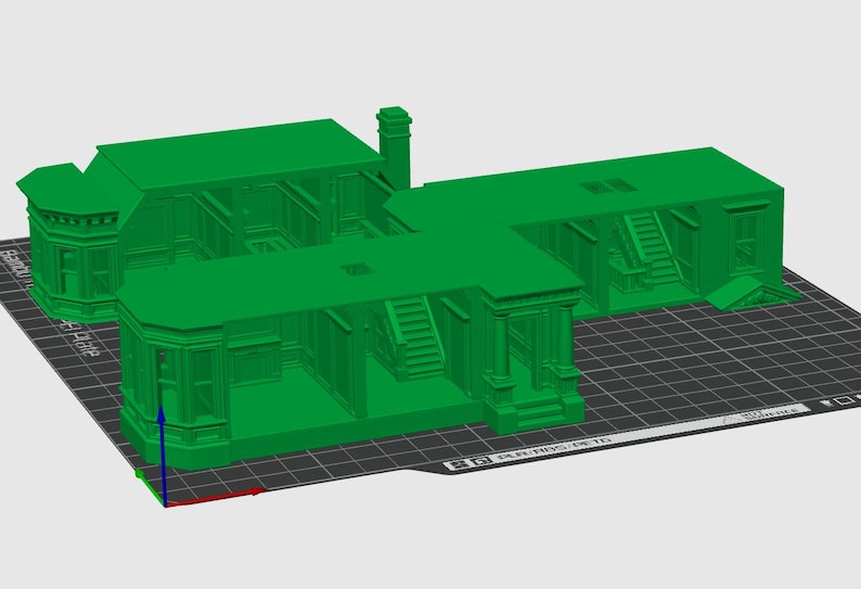 May include: A bright green 3D printed model of a multi-room building structure featuring architectural details such as bay windows, interior staircases, and doorways. The model is displayed on a digital grid platform with a coordinate axis indicator.