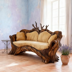 May include: A unique, handcrafted sofa with a tree trunk design. The wooden frame is intricately carved, featuring branches at the back and a curved seat. It has tan cushions and pillows. The sofa is a statement piece for a rustic or nature-inspired living space.