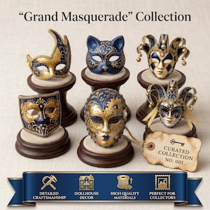 May include: A collection of five miniature masquerade masks in blue and gold, displayed on individual wooden stands. The set includes a cat mask, jester masks, and ornate face masks. A tag reads Curated Collection No. 001 with a key icon.